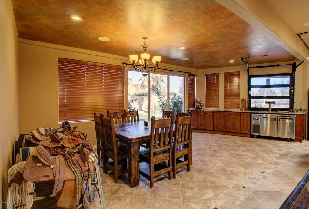 Open concept kitchen with wood ceiling, travertine floors, custom cabinetry, and dining area