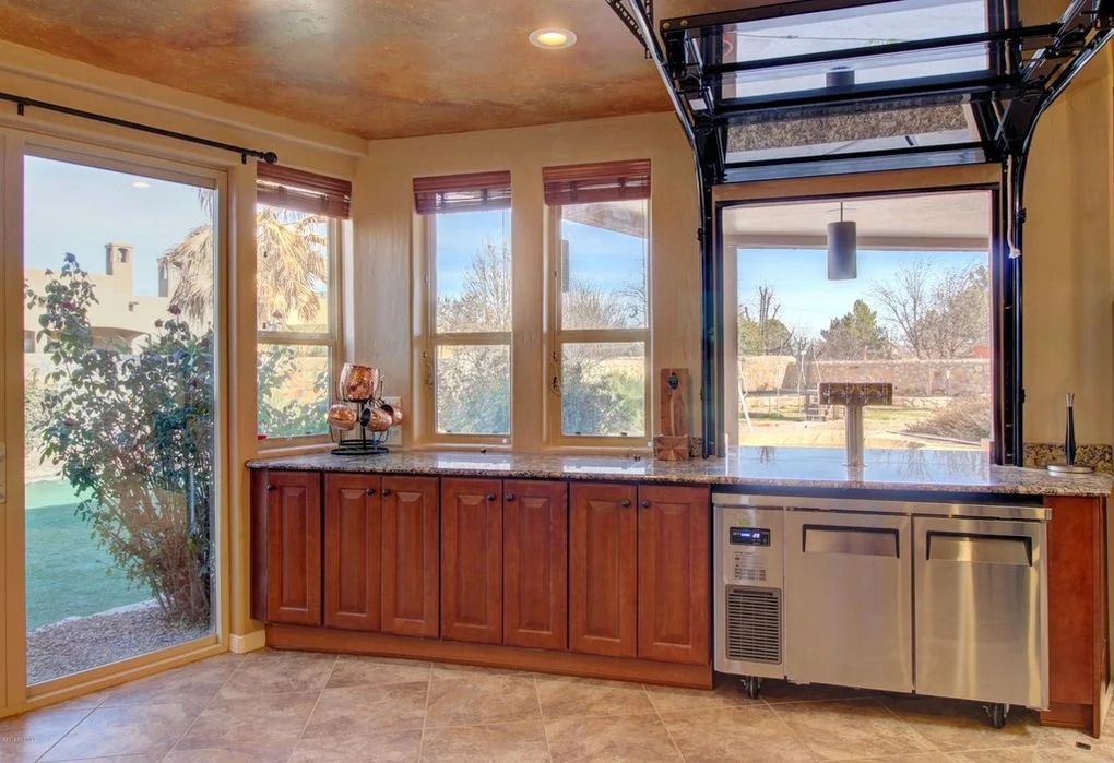 Custom wood windows, glass garage doors, cherry cabinetry, granite counters, stainless steel appliances in kitchen