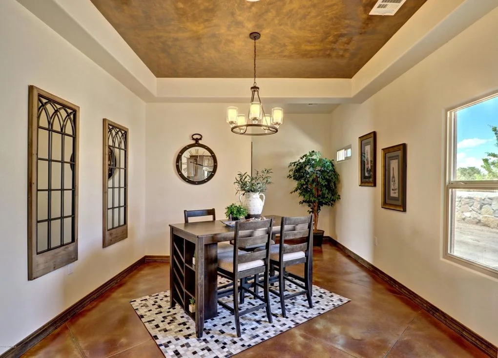 Sunroom with metallic gold ceiling, concrete floors, and large windows