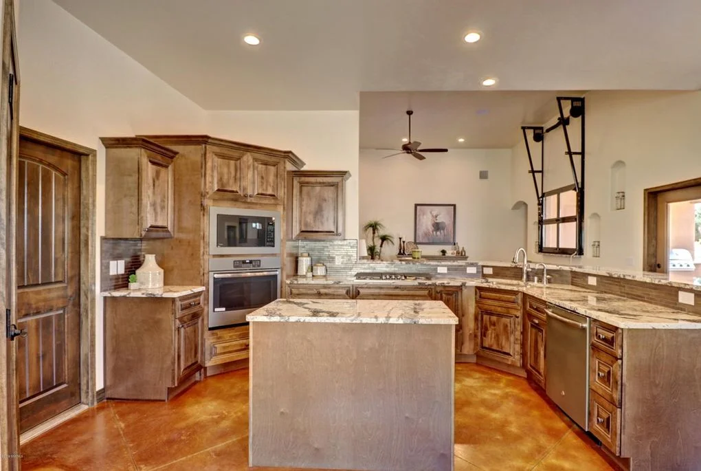 Custom wood kitchen cabinets, granite countertops, central island, stainless steel appliances, recessed lighting